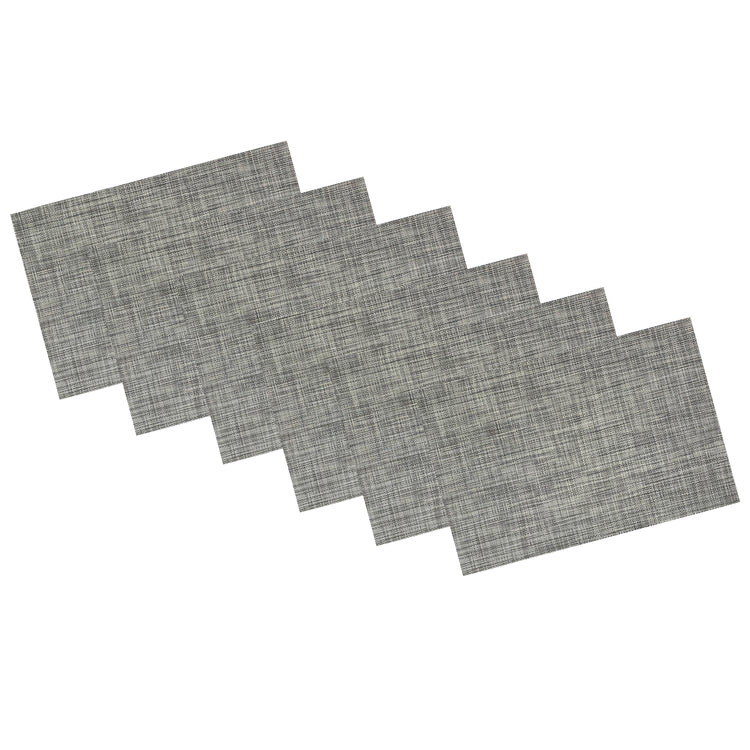 Charcoal | Set of 6 woven placemats in charcoal color stacked neatly on a white background.