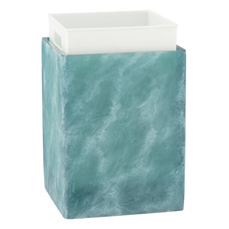 Turquoise | Wastebasket on a white surface with white liner showing.
