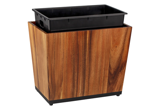 Acacia | Taniya Nayak wood wastebasket with the full liner propped up on a white background.