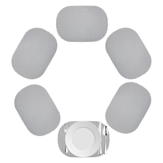 Ultimate Gray | Oval shaped fishnet placemat set with white dinner plate and utensils.