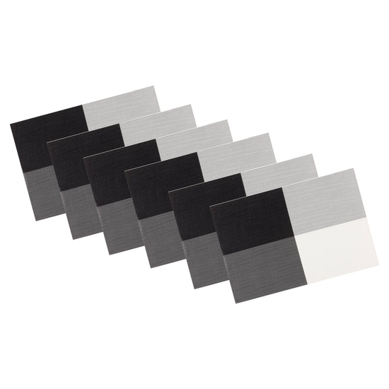 Black & White | Set of 6 woven placemats with four corner design, neatly stacked on a white background.
