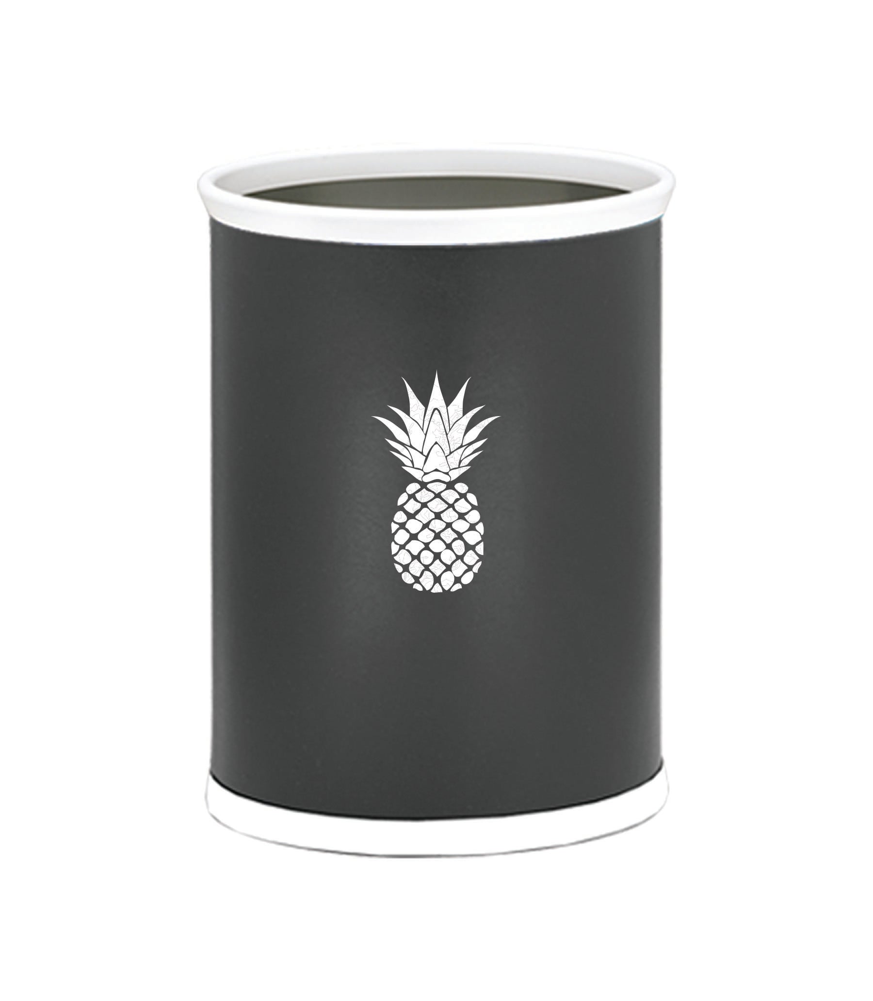 Black | Oval wastebasket featuring smooth leatherette and a white pineapple design adding a fresh touch to a coastal-themed room.