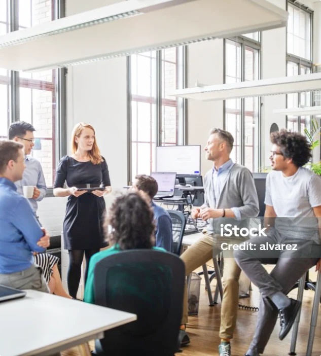 Multi | Image of employees gathering for a meeting.